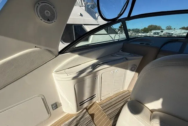 Slide: The Image of Interior view of 2000 Sea Ray 340 Sundancer yacht cockpit with beige seating. - 13