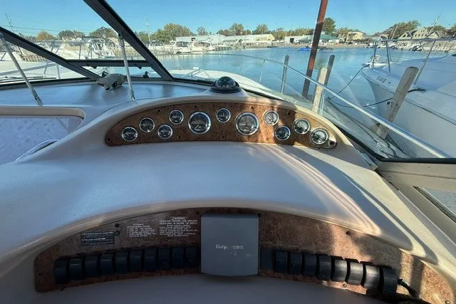 Slide: The Image of Dashboard of a 2000 Sea Ray 340 Sundancer boat with gauges and controls. - 21