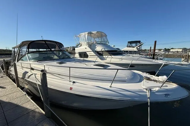 Slide: The Image of 2000 Sea Ray 340 Sundancer docked at marina under clear blue sky. - 4