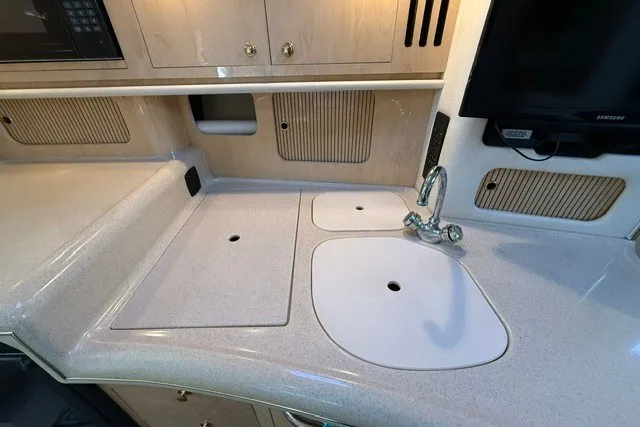 Slide: The Image of Kitchen area of 2000 Sea Ray 340 Sundancer yacht with sink and countertop. - 32
