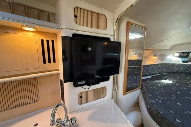 Slide: The Image of Interior of 2000 Sea Ray 340 Sundancer with TV, sink, and cozy sleeping area. - 36