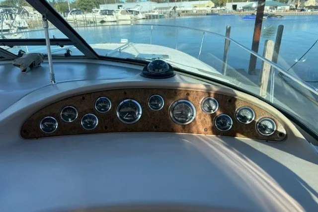 Slide: The Image of Dashboard of a 2000 Sea Ray 340 Sundancer boat with gauges and compass. - 22