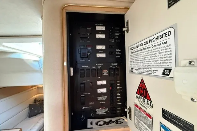 Slide: The Image of Electrical panel inside a 2000 Sea Ray 340 Sundancer boat cabin with safety warnings. - 35