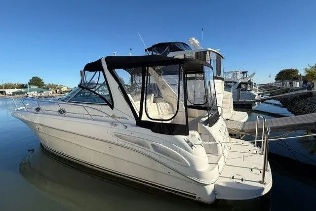 Slide: The Image of 2000 Sea Ray 340 Sundancer yacht docked at marina under clear blue sky. - 1