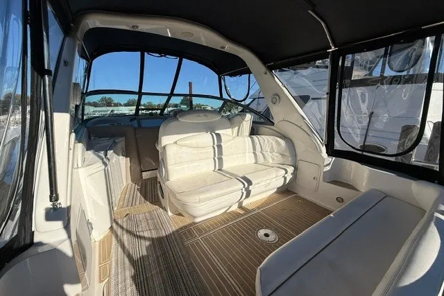Slide: The Image of Interior of 2000 Sea Ray 340 Sundancer yacht with white seating and wood flooring. - 7