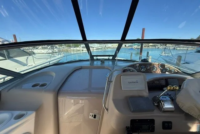 Slide: The Image of Cockpit view of 2000 Sea Ray 340 Sundancer yacht with marina background. - 17