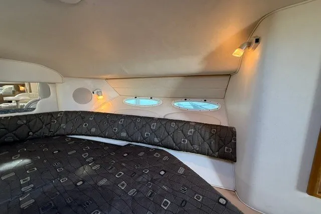Slide: The Image of Interior cabin of 2000 Sea Ray 340 Sundancer with cozy lighting and patterned upholstery. - 40