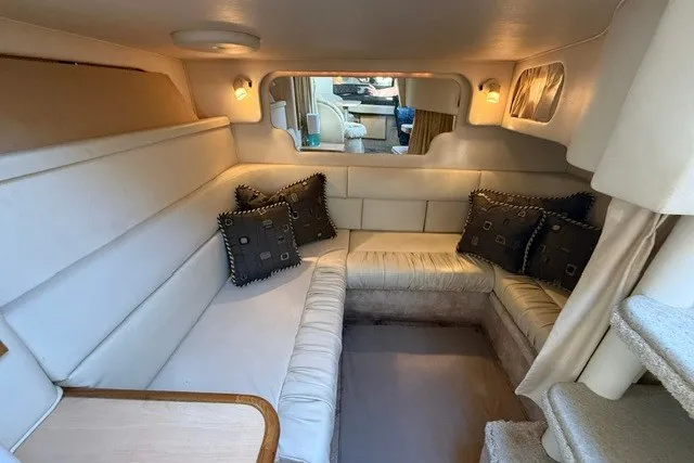 Slide: The Image of Interior of 2000 Sea Ray 340 Sundancer with cozy seating and decorative pillows. - 49