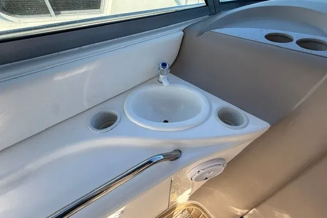 Slide: The Image of Cockpit sink area on 2000 Sea Ray 340 Sundancer boat with cup holders. - 14