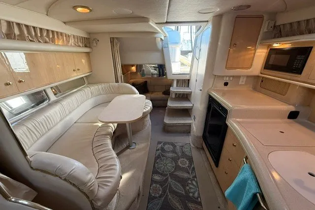 Slide: The Image of Interior of a 2000 Sea Ray 340 Sundancer yacht with kitchen and seating area. - 42
