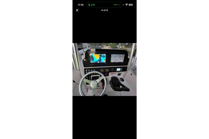 Slide: The Image of 2006 Hydra-Sports Vector 2500 CC boat dashboard with navigation screens and steering wheel. - 1