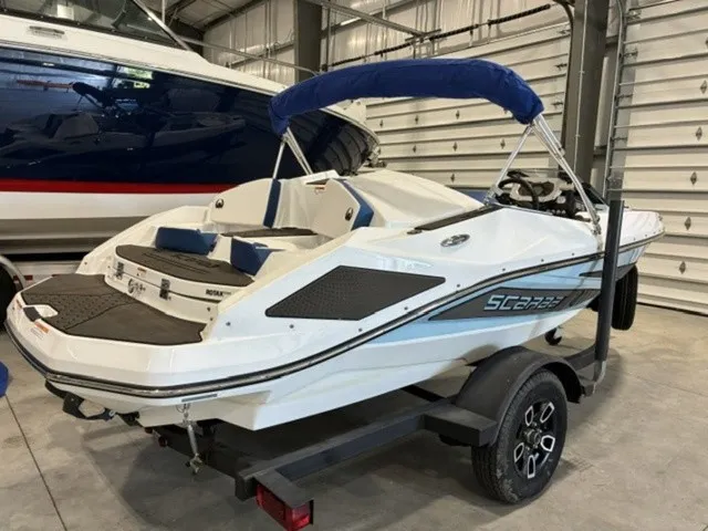 The Image of Scarab 165 ID 2022 in a storage facility, on a trailer, with a blue cover. - 0