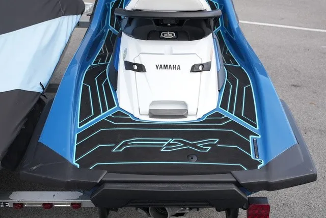 Slide: The Image of 2024 Yamaha WaveRunner FX Cruiser HO with blue and black design, on a trailer. - 5