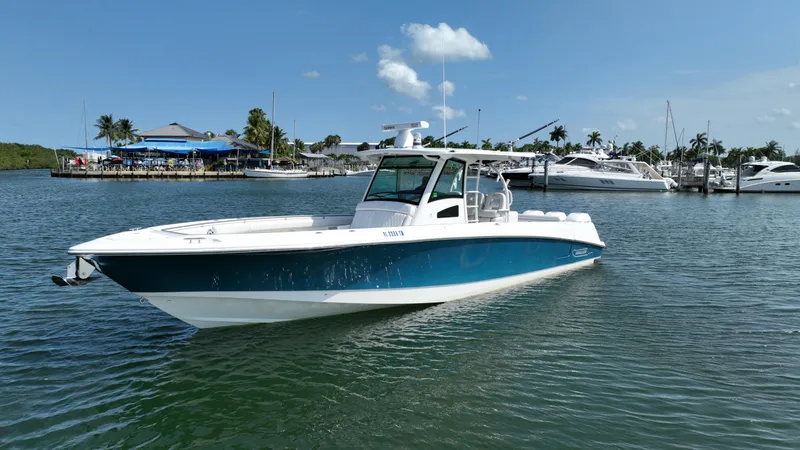Slide: The Image of Ein Boston Whaler 380 Outrage von 2017 auf dem Wasser, umgeben von anderen Booten und Palmen. - 8