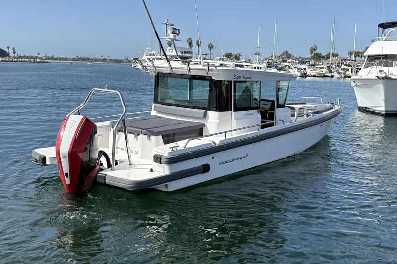 Slide: The Image of 2021 Axopar 28 Cabin boat with red outboard motor in marina. - 7