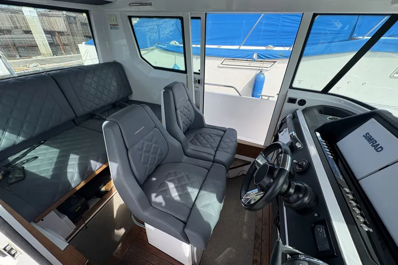 Slide: The Image of Interior of 2021 Axopar 28 Cabin boat with modern seating and navigation equipment. - 9