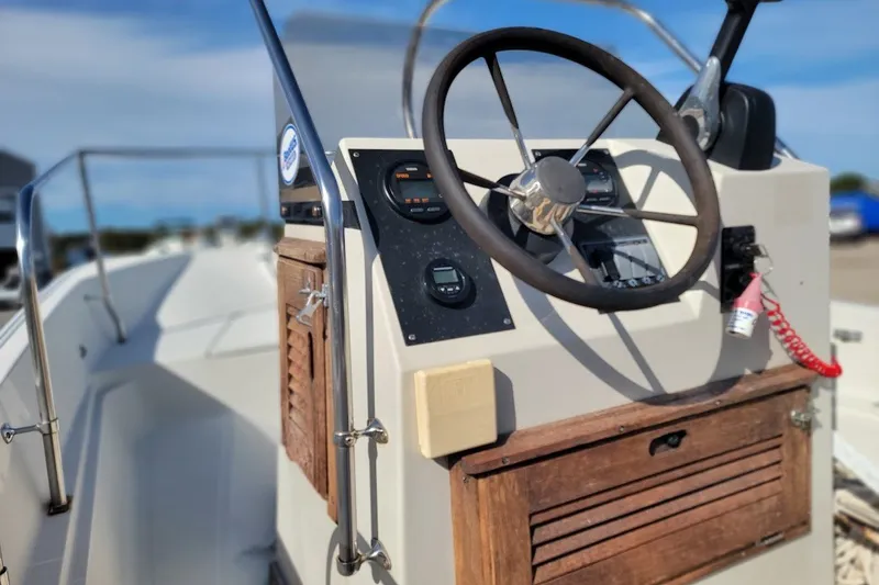 Slide: The Image of 1986 Boston Whaler 17 Montauk boat console with steering wheel and gauges. - 12