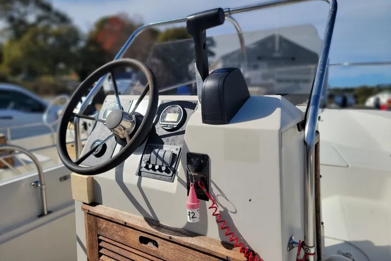 Slide: The Image of 1986 Boston Whaler 17 Montauk boat console with steering wheel and controls. - 20
