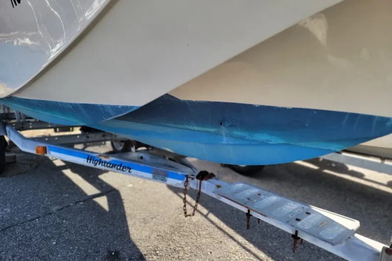 Slide: The Image of 1986 Boston Whaler 17 Montauk boat on Highlander trailer, showing hull detail. - 19