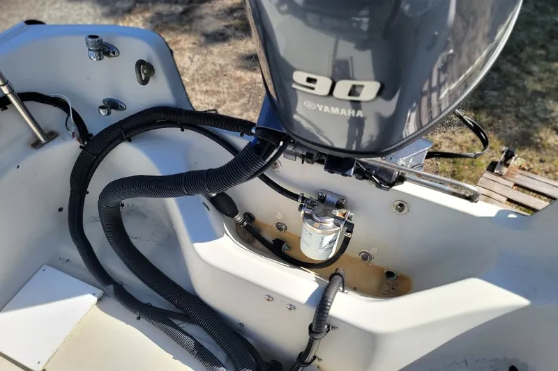 Slide: The Image of 1986 Boston Whaler 17 Montauk with Yamaha 90 engine, detailed view of motor and wiring. - 18