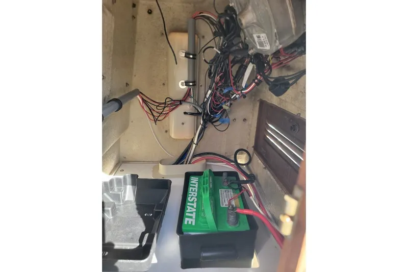 Slide: The Image of 1986 Boston Whaler 17 Montauk interior wiring and battery compartment view. - 14