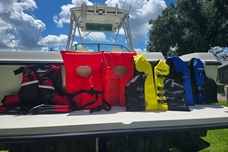 Slide: The Image of Life jackets on a 2005 Trophy 2352 Walkaround boat under a sunny sky. - 21