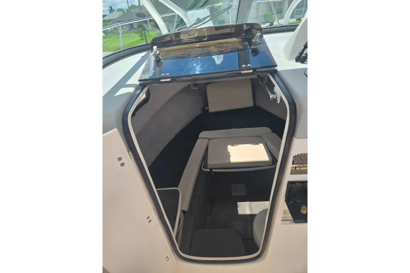 Slide: The Image of 2005 Trophy 2352 Walkaround cabin interior with seating and storage. - 13