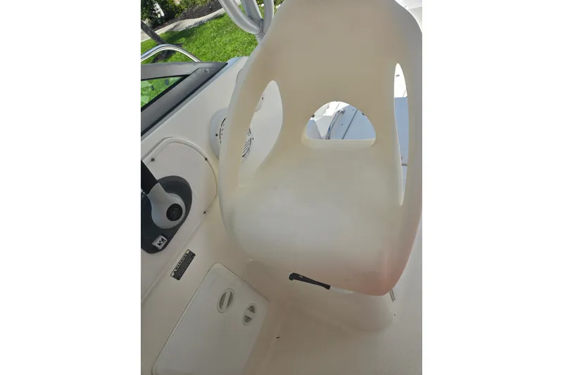 Slide: The Image of Captain's seat on 2005 Trophy 2352 Walkaround boat, featuring steering controls. - 17