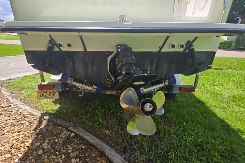 Slide: The Image of Rear view of a 2005 Trophy 2352 Walkaround boat on a trailer, showing propeller and license plate. - 48