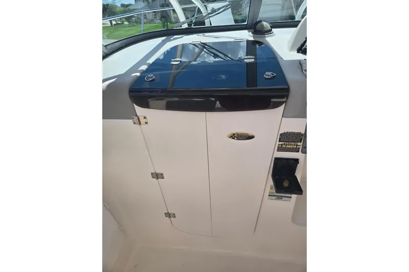 Slide: The Image of 2005 Trophy 2352 Walkaround boat dashboard with storage compartment. - 28