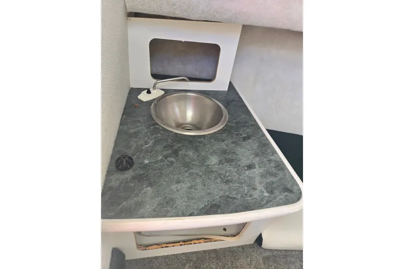 Slide: The Image of 2005 Trophy 2352 Walkaround boat interior sink with countertop. - 43