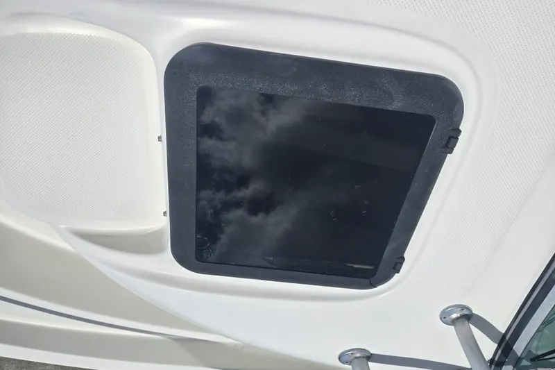 Slide: The Image of Hatch on 2005 Trophy 2352 Walkaround boat, reflecting cloudy sky. - 15