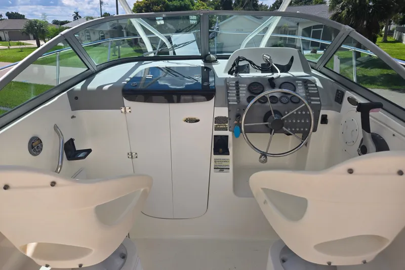 Slide: The Image of 2005 Trophy 2352 Walkaround boat cockpit with steering wheel and control panel. - 27