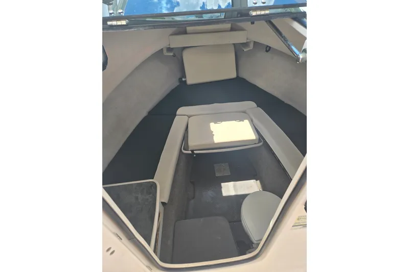 Slide: The Image of 2005 Trophy 2352 Walkaround cabin interior with seating and storage. - 37