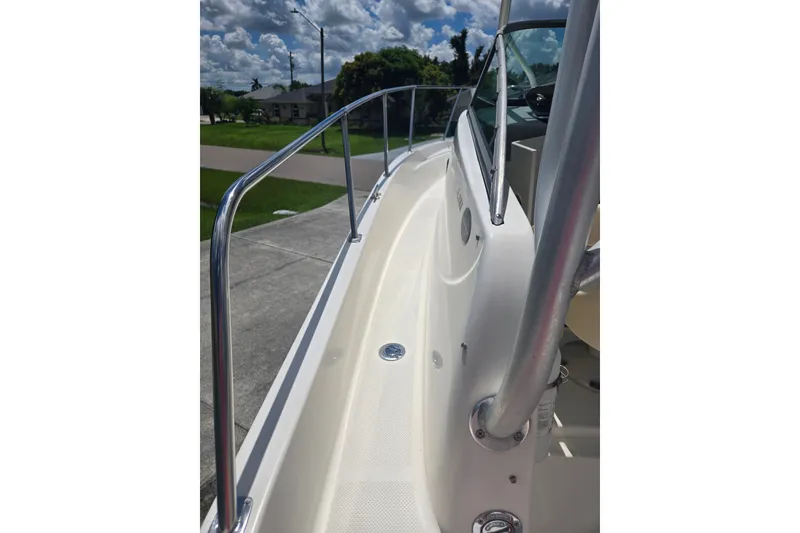 Slide: The Image of 2005 Trophy 2352 Walkaround boat deck with railing under a sunny sky. - 31