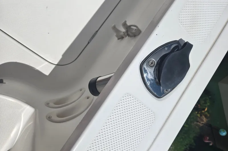 Slide: The Image of 2005 Trophy 2352 Walkaround boat deck detail with rod holders and latch. - 29