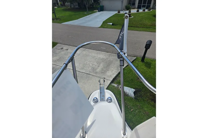 Slide: The Image of Bow view of a 2005 Trophy 2352 Walkaround boat parked in a driveway. - 36