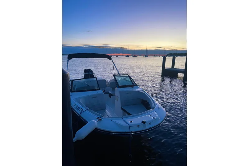 Slide: The Image of 2022 Sea Ray SPX 190 boat docked at sunset on calm waters. - 4