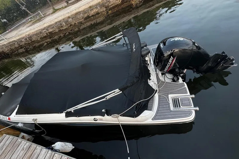 Slide: The Image of 2022 Sea Ray SPX 190 boat with Mercury engine docked in calm water. - 10