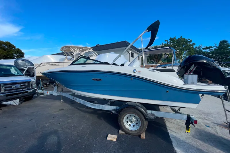 Slide: The Image of 2022 Sea Ray SPX 190 boat on trailer, blue hull, parked outdoors. - 6