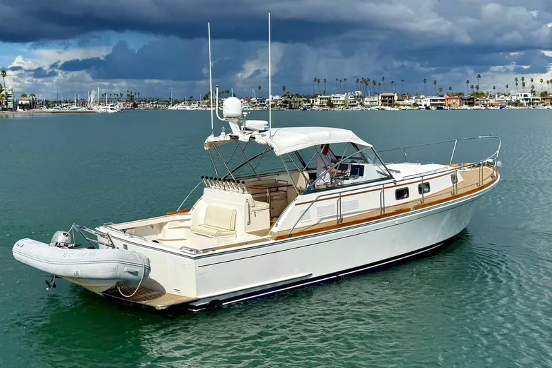 Slide: The Image of 1999 Grand Banks 38 Eastbay EX yacht on calm water under cloudy sky. - 3