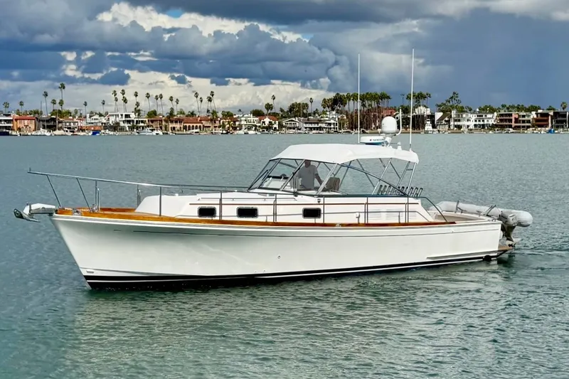 The Image of 1999 Grand Banks 38 Eastbay EX yacht on calm water under cloudy sky. - 0