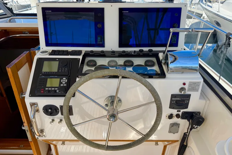 Slide: The Image of Helm of 1999 Grand Banks 38 Eastbay EX with navigation equipment and steering wheel. - 16