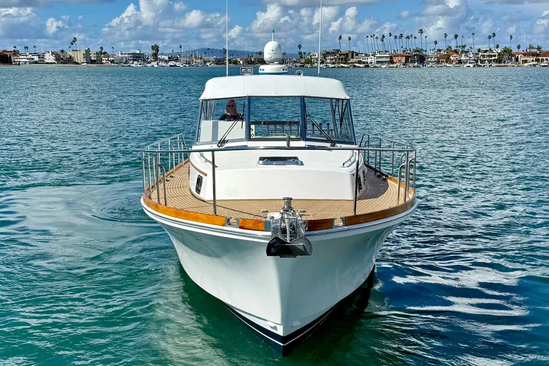 Slide: The Image of 1999 Grand Banks 38 Eastbay EX yacht on calm water, clear sky background. - 8