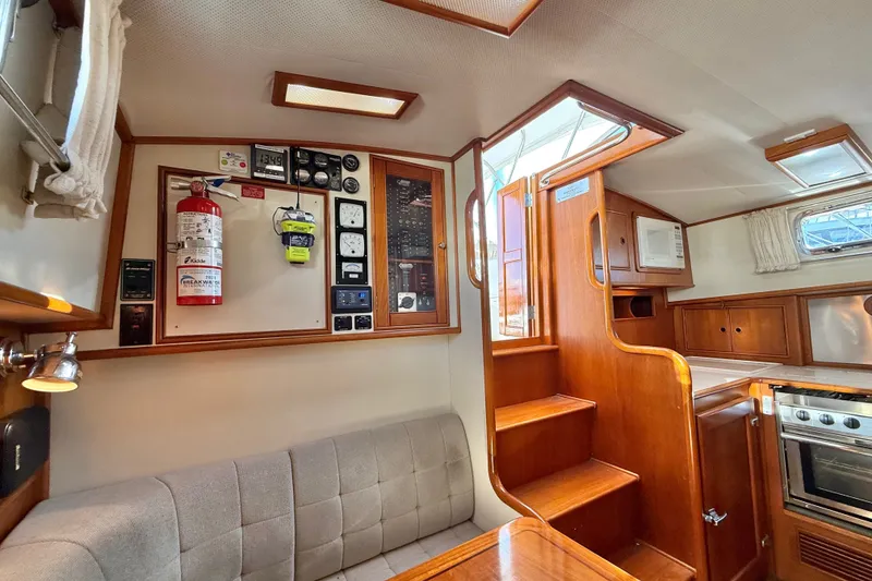 Slide: The Image of Interior of 1999 Grand Banks 38 Eastbay EX with control panel, stairs, and kitchen area. - 39