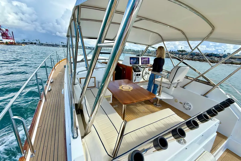 Slide: The Image of 1999 Grand Banks 38 Eastbay EX yacht with helm, seating, and ocean view. - 11