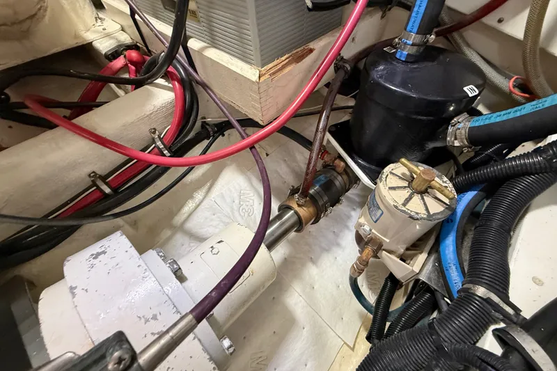 Slide: The Image of Engine compartment of a 1999 Grand Banks 38 Eastbay EX with visible wiring and components. - 49