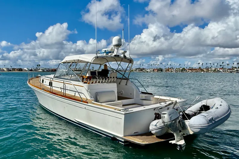 Slide: The Image of 1999 Grand Banks 38 Eastbay EX yacht on calm water under a partly cloudy sky. - 2
