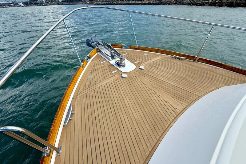 Slide: The Image of Bow of 1999 Grand Banks 38 Eastbay EX yacht with teak decking on water. - 18