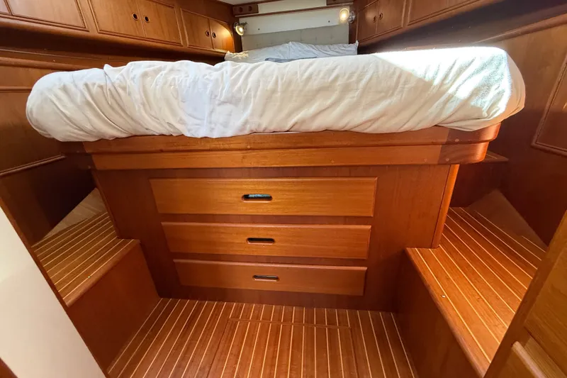 Slide: The Image of Wooden cabin interior of 1999 Grand Banks 38 Eastbay EX with bed and storage drawers. - 36